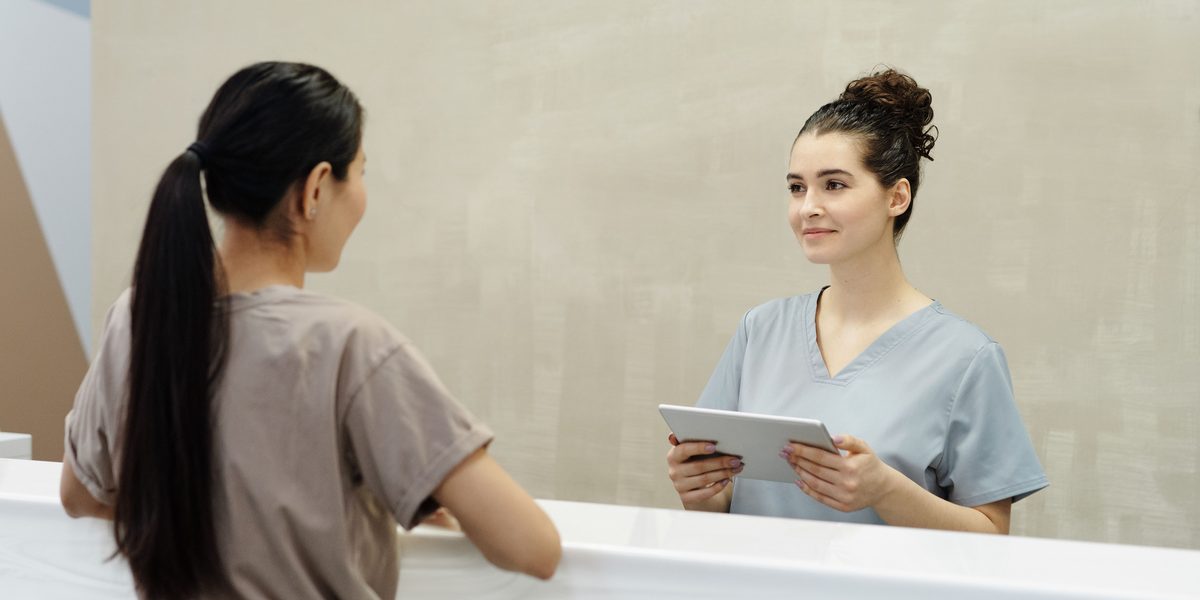 A front desk team member working at the practice counter.